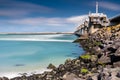 View on the architecture of the flood barrier `Neeltje jans` in the Netherlands from the rocky coast with seaweed and splashing Royalty Free Stock Photo