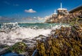 View on the architecture of the flood barrier `Neeltje jans` in the Netherlands from the rocky coast with seaweed and splashing Royalty Free Stock Photo