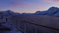 View of the arctic ocean and snow-covered mountains from upper deck of cruise ship near ÃËksfjord, Norway in evening light. Royalty Free Stock Photo