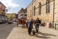 A view of the area and buildings outside of the Cathedral, in Lincoln, UK, with a horse and cart on Royalty Free Stock Photo