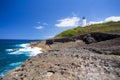 Arecibo lighthouse from Puerto Rico coast with rocky shore and ocean