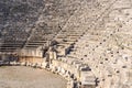 View of the arena and stands of the antique amphitheater in the ruins of Myra Demre, Turkey Royalty Free Stock Photo