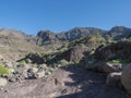 View of arid subtropical landscape of Barranco de Guigui Grande ravine with cacti and palm trees viewed from hiking