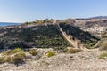 View of an arid terrain with the wall and the Alcazaba in the background in Almeria Spain