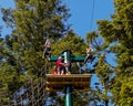 People on a tree top adventure climbing frame