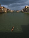 View of Arno river with person doing kayaking and showing traditional architecture along the river. Royalty Free Stock Photo