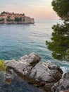 View as a postcard: rocky beach, turquoise sea and ancient city in the distance Royalty Free Stock Photo