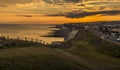 A view as the sun sinks low in the sky from Saltdean looking towards Brighton, UK