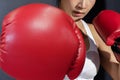 View of Asian Woman with Red Boxing Glove Punching to her Front Opponent Royalty Free Stock Photo