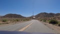 View of an asphalt road through rural areas in Tehachapi, California