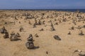 View of Atlantic Ocean coastline decorated with small pyramids made of stones. Aruba, North side. Royalty Free Stock Photo