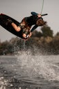 view of attractive man doing wakeboard flip while holding rope with his hand Royalty Free Stock Photo