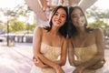 View of attractive smiling asian woman looking at camera wearing yellow dress Royalty Free Stock Photo