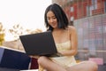 View of attractive young brunette sitting and working on laptop Royalty Free Stock Photo