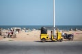 View of a auto rickshaw and a motorbike by Chennai Beach, Tamil Nadu, India