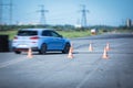 View of autodrome race circuit racetrack with a line of cars driving and racing, with audience and during rally autocross racing