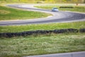 View of autodrome race circuit racetrack with a line of cars driving and racing, with audience and during rally autocross racing