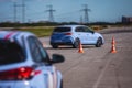 View of autodrome race circuit racetrack with a line of cars driving and racing, with audience and during rally autocross racing