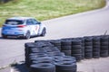 View of autodrome race circuit racetrack with a line of cars driving and racing, with audience and during rally autocross racing