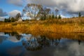 Autumn landscape with colorful trees, yellow grass and river. Re Royalty Free Stock Photo