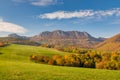View of autumn landscape with rocky mountains in the background Royalty Free Stock Photo