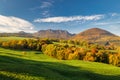 View of autumn landscape with rocky mountains in the background Royalty Free Stock Photo