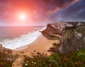 View of Azenhas do Mar at sunset. Big waves Atlantic Ocean crashing into the rocky shore. Dramatic view of the colorful sky. Sintr Royalty Free Stock Photo