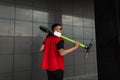 View from the back on an American young man with a hairstyle in a stylish red vest in sunglasses with an electric scooter in hands Royalty Free Stock Photo