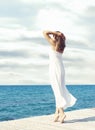 View from the back of beautiful and healthy girl on wooden pier. Vacation, resort and traveling. Royalty Free Stock Photo