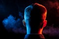 A view from the back on the head of a man in a shirt smoking a v Royalty Free Stock Photo