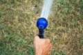 View from the back image The hand is holding the sprinkler the tree Royalty Free Stock Photo