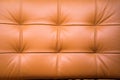 View of the back of a leather sofa light brown stitched thread bumps. Backgrounds, structures, interior Royalty Free Stock Photo