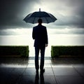 View from the back of a lonely man under an umbrella during the rain looks thoughtfully into the distance on the embankment Royalty Free Stock Photo