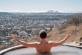 view from back. a man bathes in a hydrogen sulfide thermal spring. Royalty Free Stock Photo