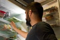 View from the back of a person opening the door of the fridge to catch something inside Royalty Free Stock Photo