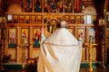 view from the back. priest at the iconostasis during the divine service.