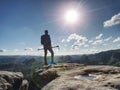 View back of tourist in sports clothes with sticks on mountain