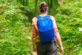 View from the back of a woman with a backpack walking through th Royalty Free Stock Photo