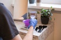 Hair dye preparation. Man hands preparing a hair dye in a plastic container Royalty Free Stock Photo