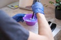 Hair dye preparation. Man hands preparing a hair dye in a plastic container Royalty Free Stock Photo