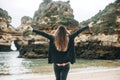 A young woman tourist enjoys beautiful views of the Atlantic Ocean and the landscape. Royalty Free Stock Photo