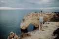 View from the back. A young woman tourist enjoys the beautiful views of the Atlantic Ocean and the landscape off the coast in Port Royalty Free Stock Photo