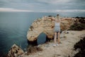 View from the back. A young woman tourist enjoys the beautiful views of the Atlantic Ocean and the landscape off the coast in Port Royalty Free Stock Photo