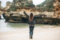 A young woman tourist enjoys beautiful views of the Atlantic Ocean and the landscape. Royalty Free Stock Photo