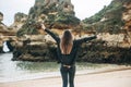 A young woman tourist enjoys beautiful views of the Atlantic Ocean and the landscape. Royalty Free Stock Photo