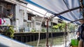View of backstreet from small boat on bangkok canal