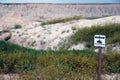 View of the Badlands with `Beware rattlesnakes` sign