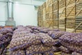 View on bags and crates of potato in storage house Royalty Free Stock Photo