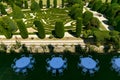 View from the balcony of the Italian landscape garden fields in summer. Round white tables stand in the yard Royalty Free Stock Photo