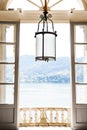 View from the balcony and from the window from an old villa on Lake Como in Italy. Antique forged lamp with a large